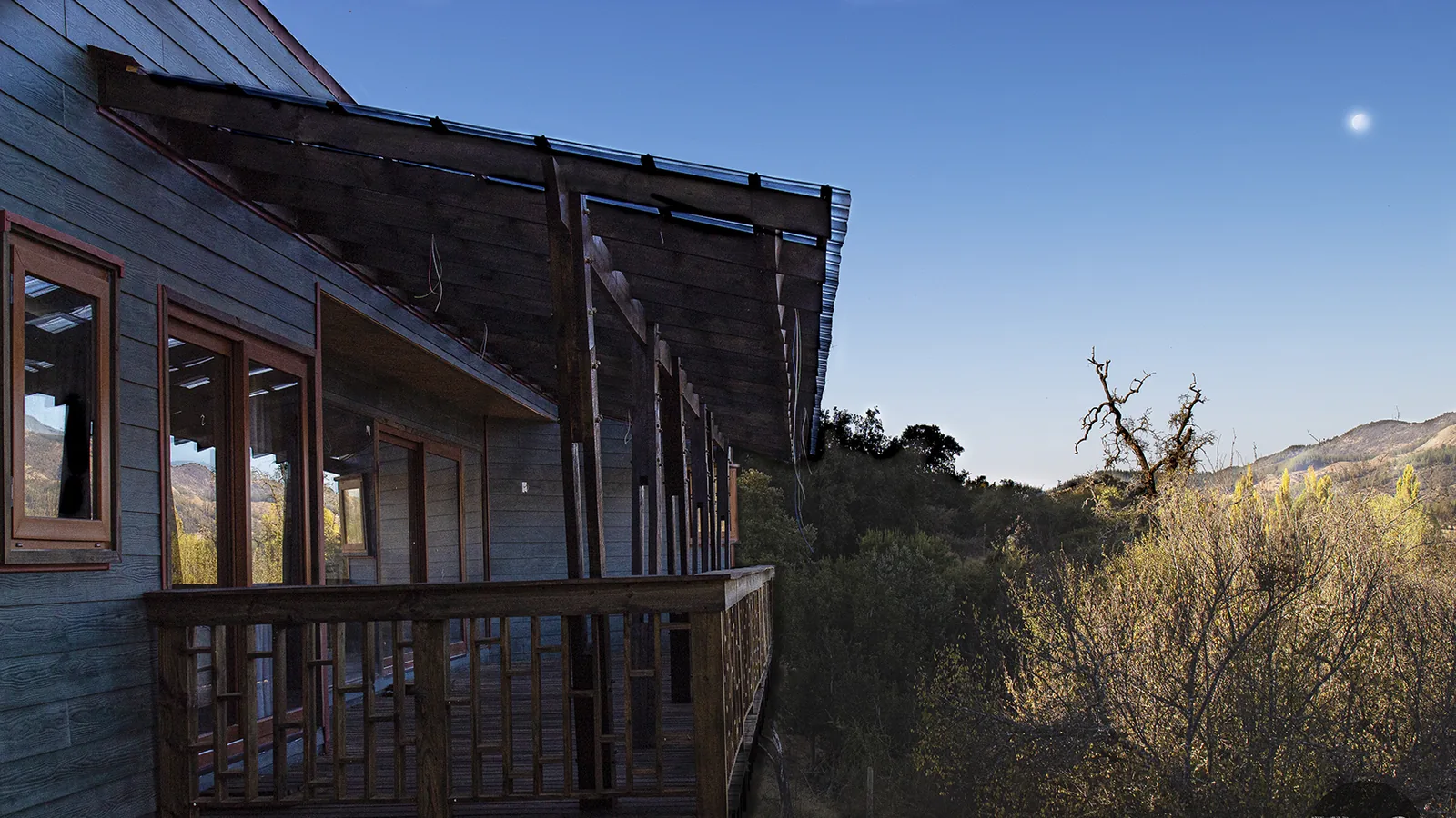 Vivienda de madera en ladera, con balcón volado sobre la quebrada — obra de CCP Arquitectura